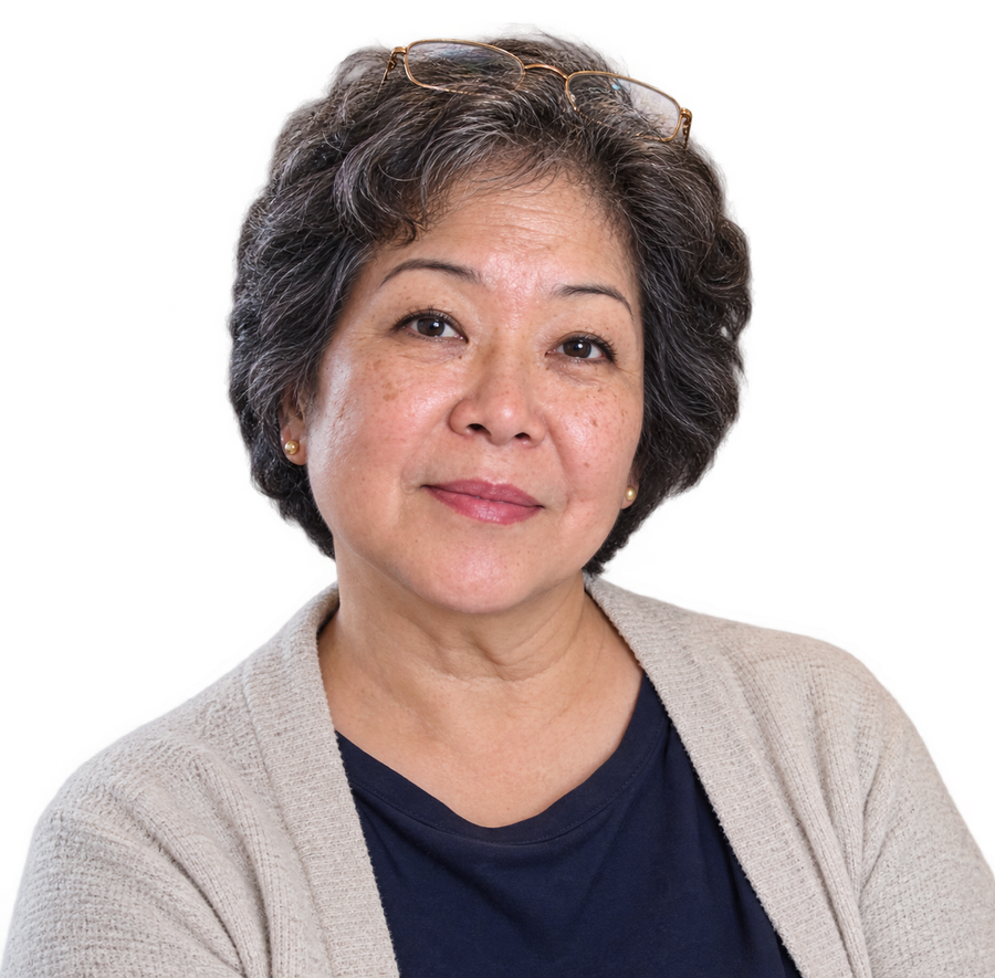Sunja Park, a woman in her sixties with short grey-rooted hair and reading glasses pushed up on her head, in an oatmeal cardigan over a navy top